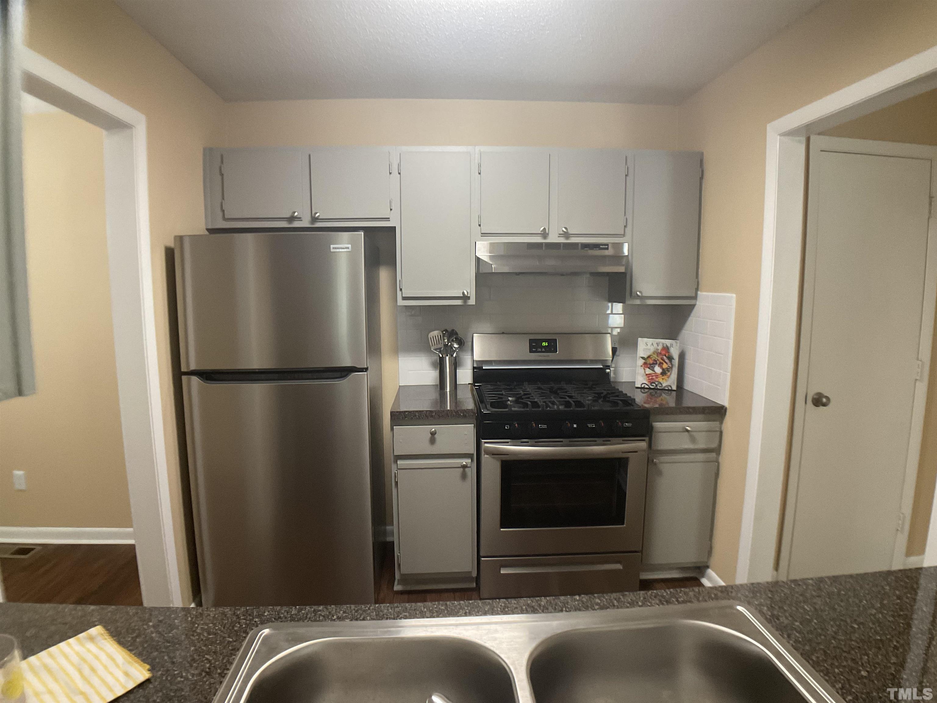5812 Pointer Drive, Unit 101 Raleigh, NC 27609 - Photo 8 of 30 a kitchen with a refrigerator stove and a sink