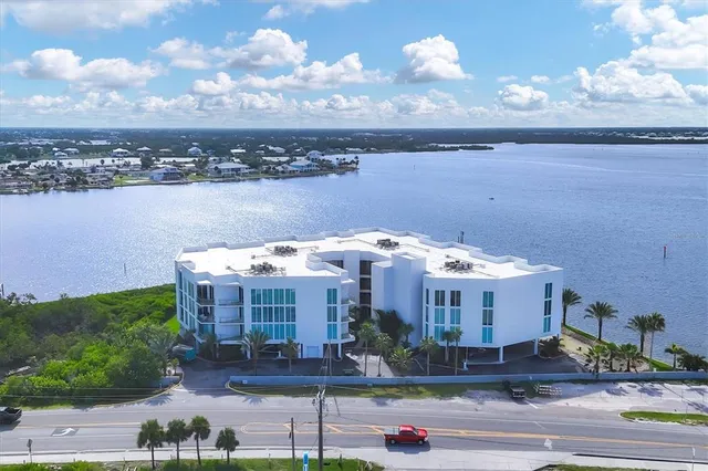 a front view of a house with a yard and lake view