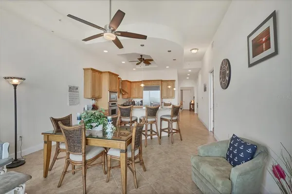 a dining room with furniture a rug and a chandelier
