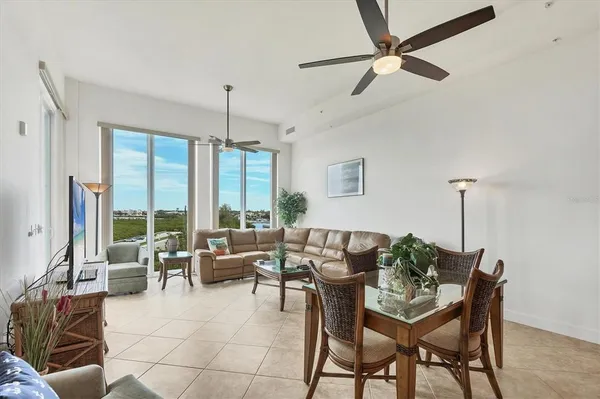 a living room with furniture and floor to ceiling windows