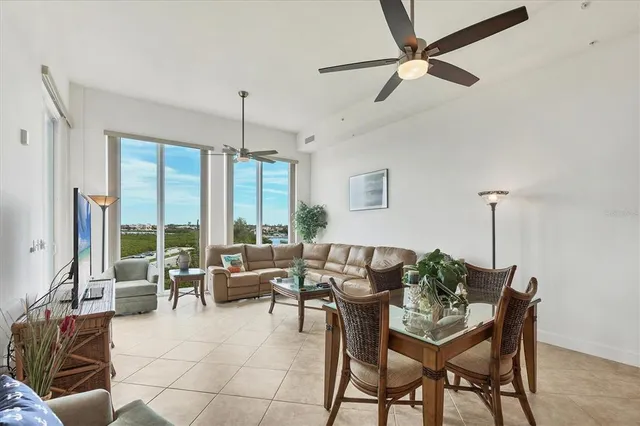 a living room with furniture and floor to ceiling windows