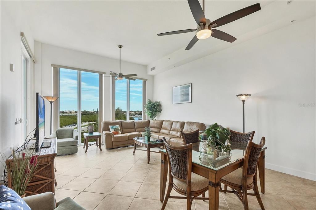 1375 Beach Road, Unit 311 Englewood, FL 34223 - Photo 17 of 51 a living room with furniture and floor to ceiling windows
