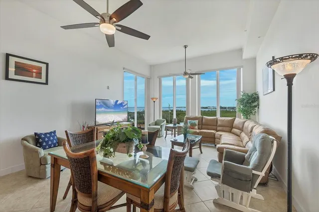 a living room with furniture a chandelier and a dining table