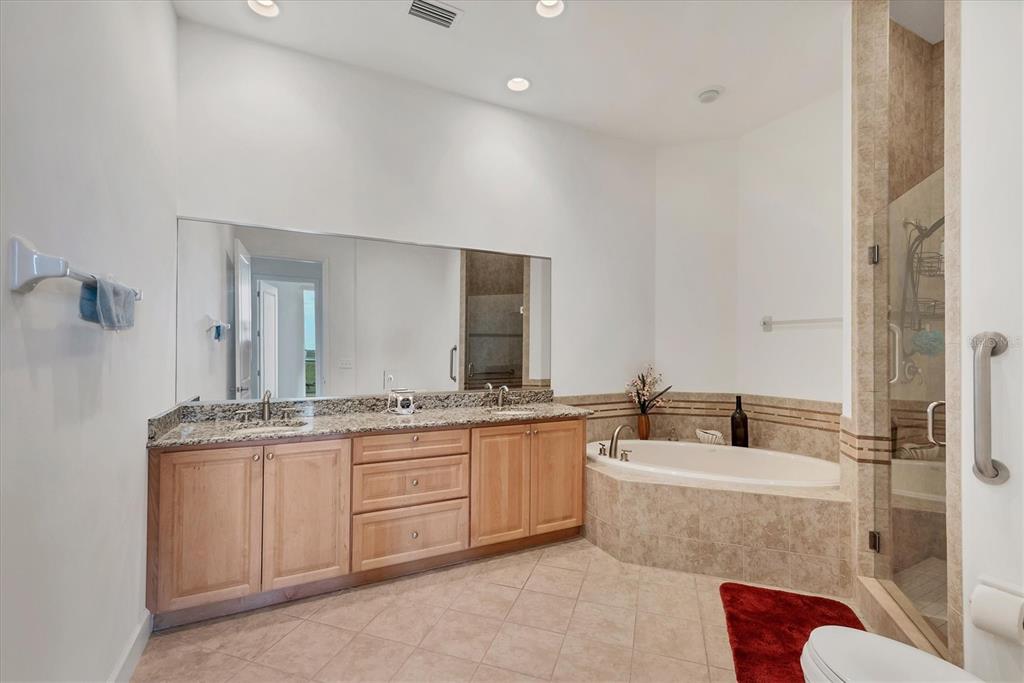 1375 Beach Road, Unit 311 Englewood, FL 34223 - Photo 19 of 51 a bathroom with a granite countertop double vanity sink a mirror and a