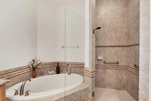 a bathroom with a tub and a shower