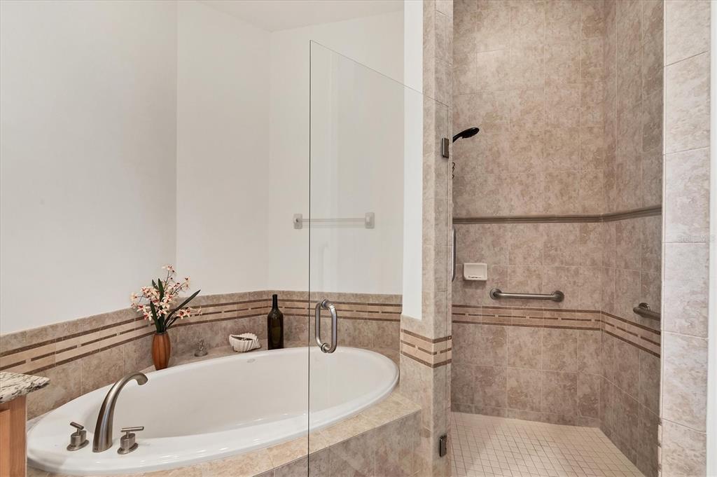 1375 Beach Road, Unit 311 Englewood, FL 34223 - Photo 23 of 51 a bathroom with a tub and a shower