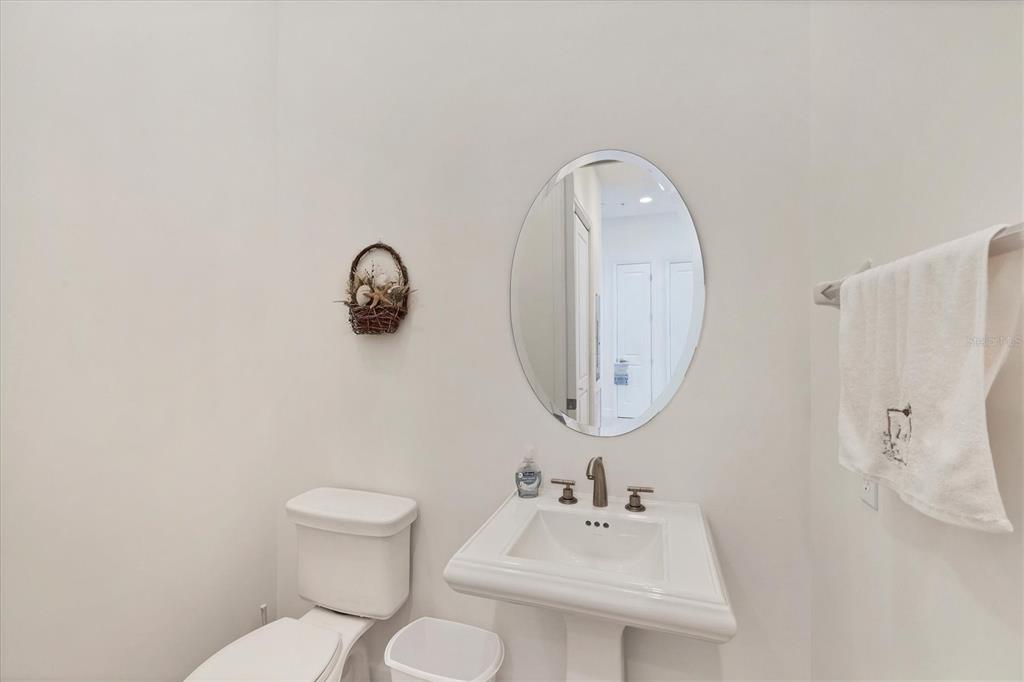 1375 Beach Road, Unit 311 Englewood, FL 34223 - Photo 29 of 51 a bathroom with a toilet sink and mirror
