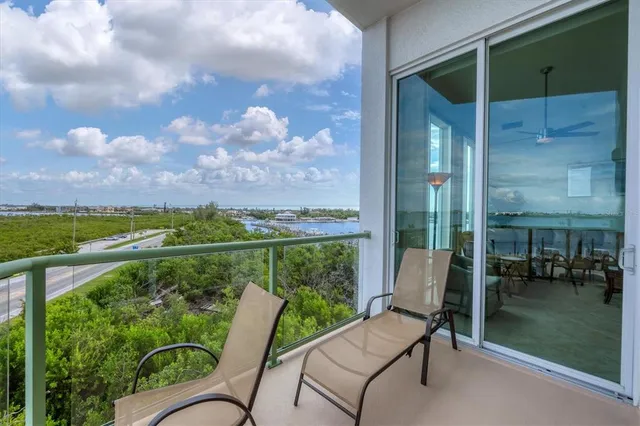 a view of a chair and tables in the balcony