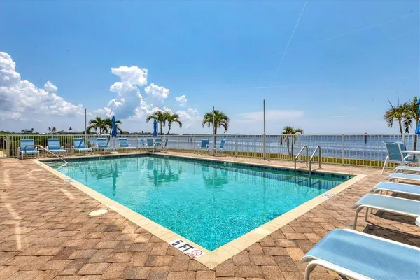 a view of a swimming pool with a lounge chair