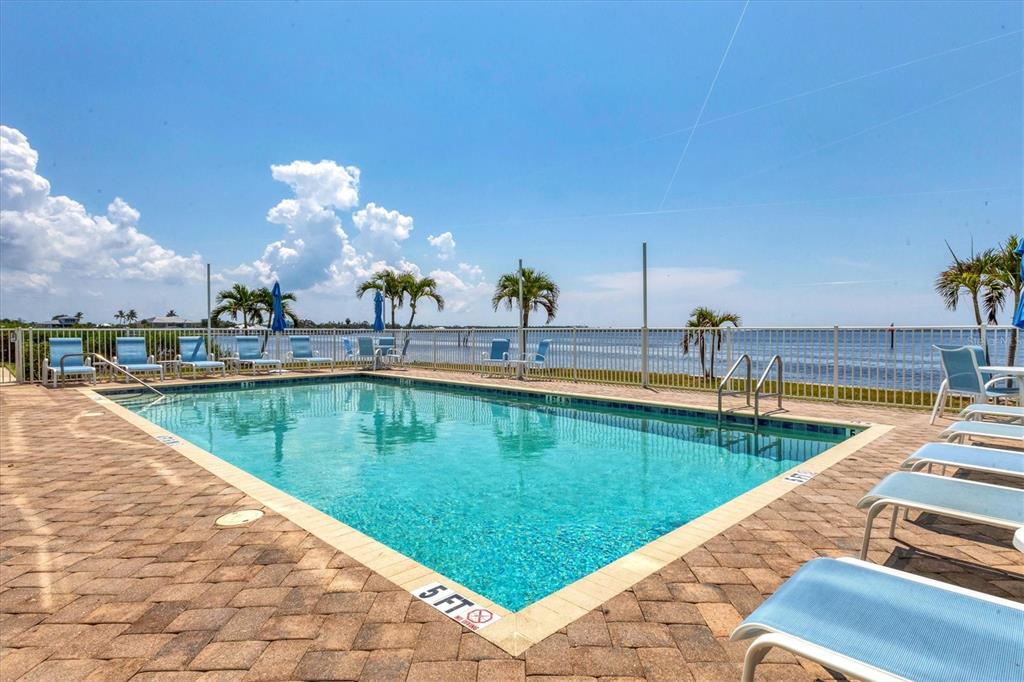 1375 Beach Road, Unit 311 Englewood, FL 34223 - Photo 39 of 51 a view of a swimming pool with a lounge chair