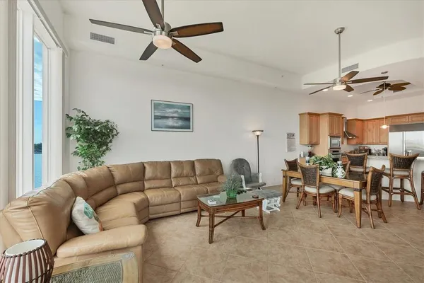 a living room with furniture a chandelier and a window
