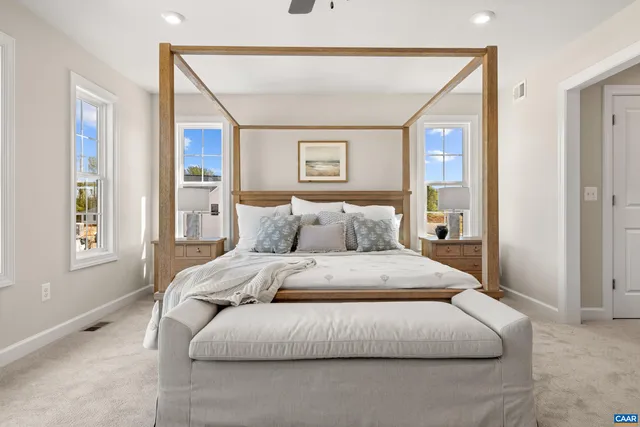a spacious bedroom with a bed and window