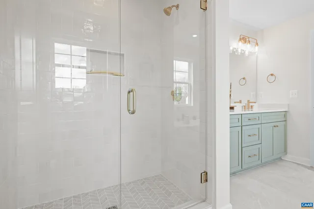 a bathroom with a shower a sink and mirror