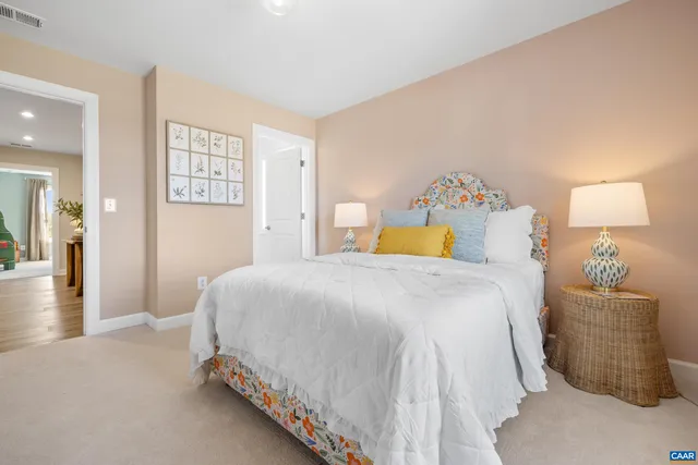 a bedroom with a bed and a lamp