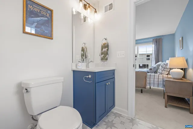 a bathroom with a toilet a sink and a mirror