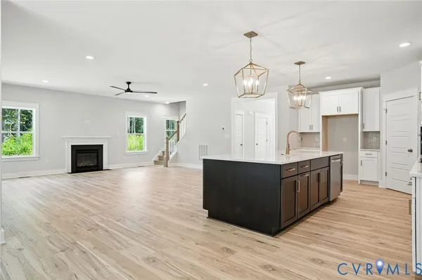 a view of a kitchen with wooden floor and a kitchen