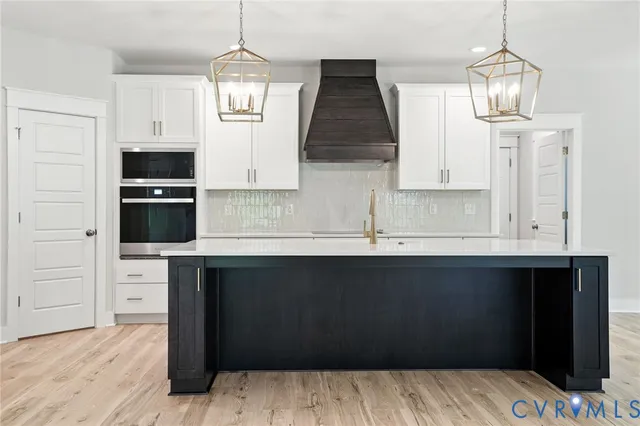 a kitchen with stainless steel appliances a sink stove and refrigerator