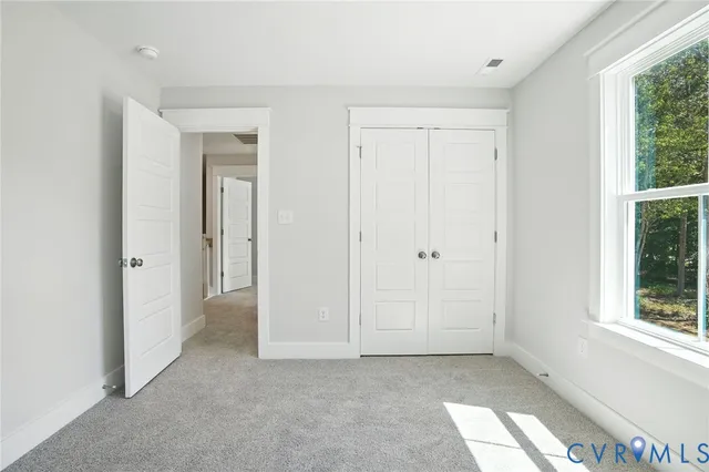 a view of a hallway with rooms