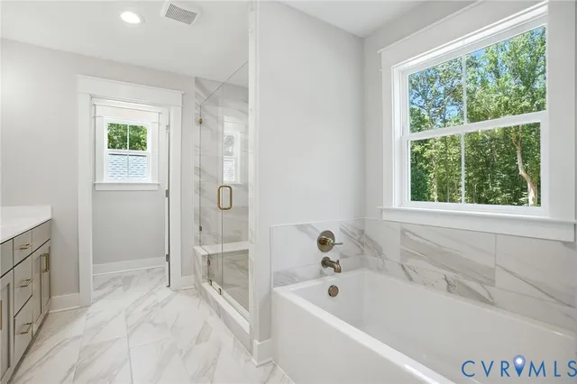 a bathroom with 2 sink shower and a mirror