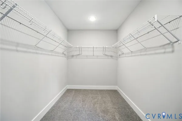 an empty room with windows and ceiling fan