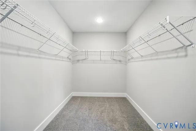 an empty room with windows and ceiling fan