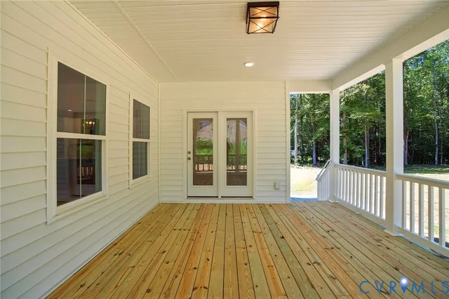 a view of a house with a yard and large tree