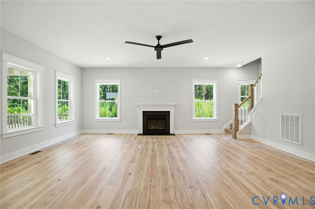 Tbd Lot 3 Rocky Ford Road Beaverdam, VA 23015 - Photo 7 of 40 an empty room with windows a fireplace and wooden floor