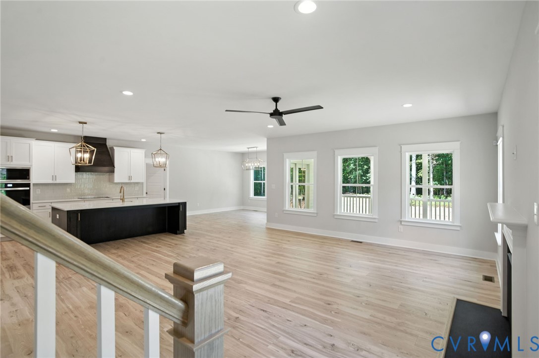 Tbd Lot 3 Rocky Ford Road Beaverdam, VA 23015 - Photo 8 of 40 a living room with stainless steel appliances kitchen island granite countertop a stove a sink a refrigerator and white cabinets with wooden floor