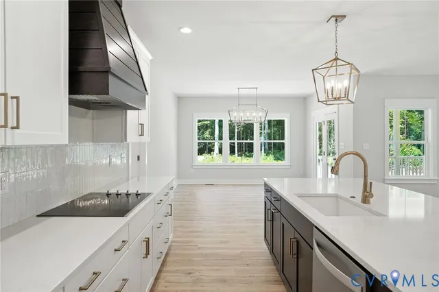 a kitchen with stainless steel appliances a sink stove and cabinets