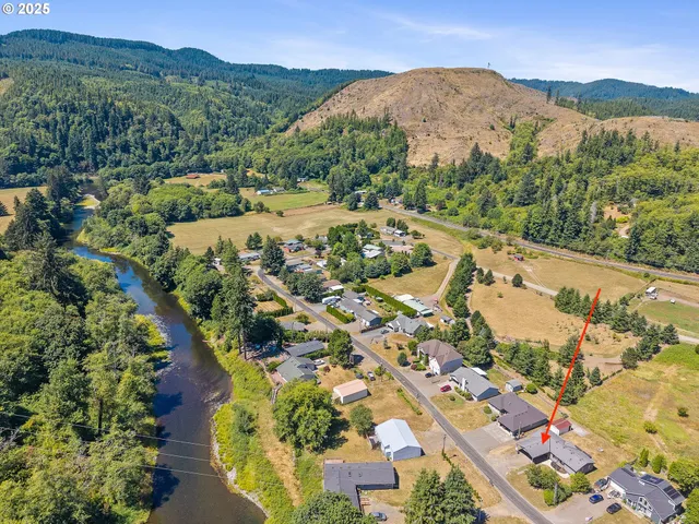 an aerial view of a residential houses with outdoor space and city view