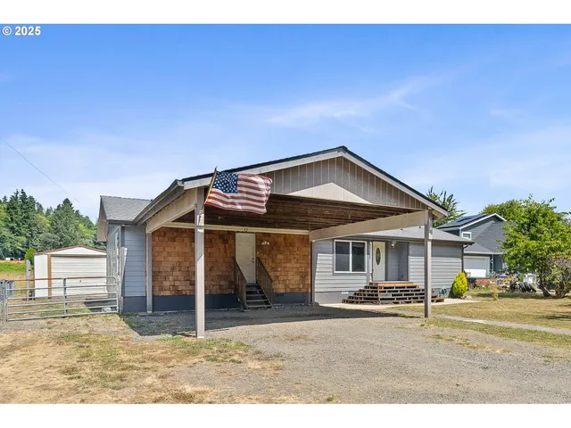 a backyard of a house with table and chairs