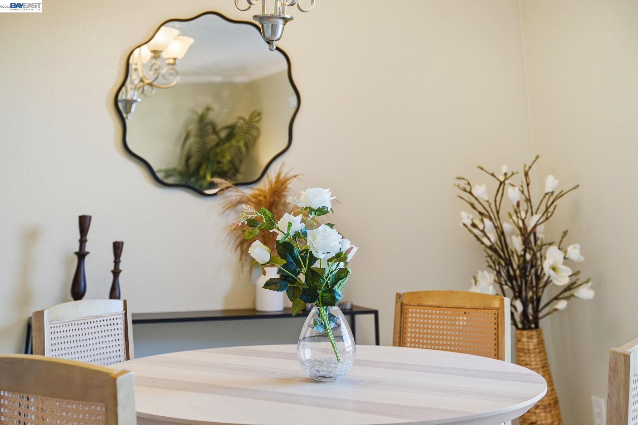 490 Bollinger Canyon Lane, Unit 367 San Ramon, CA 94582 - Photo 17 of 32 a vase of flowers sitting on a table with a mirror