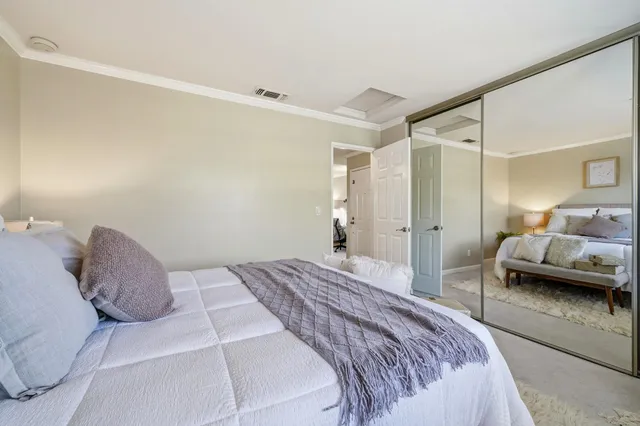 a bedroom with a bed and a couch