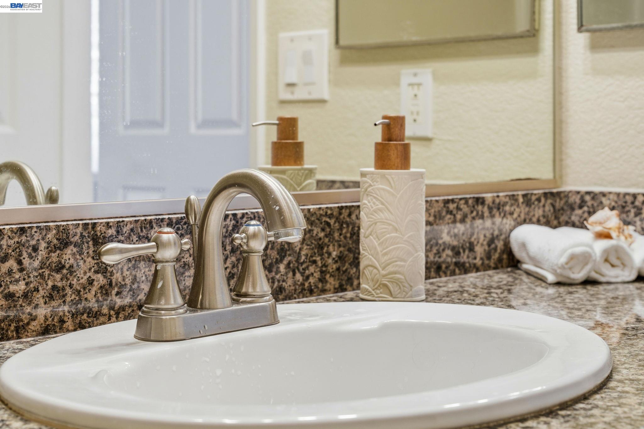490 Bollinger Canyon Lane, Unit 367 San Ramon, CA 94582 - Photo 24 of 32 a bathroom with a granite countertop sink and a mirror