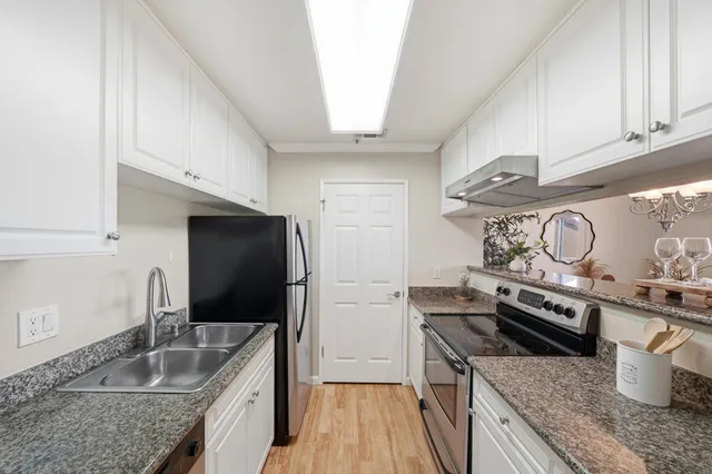 a kitchen with a stove and a sink