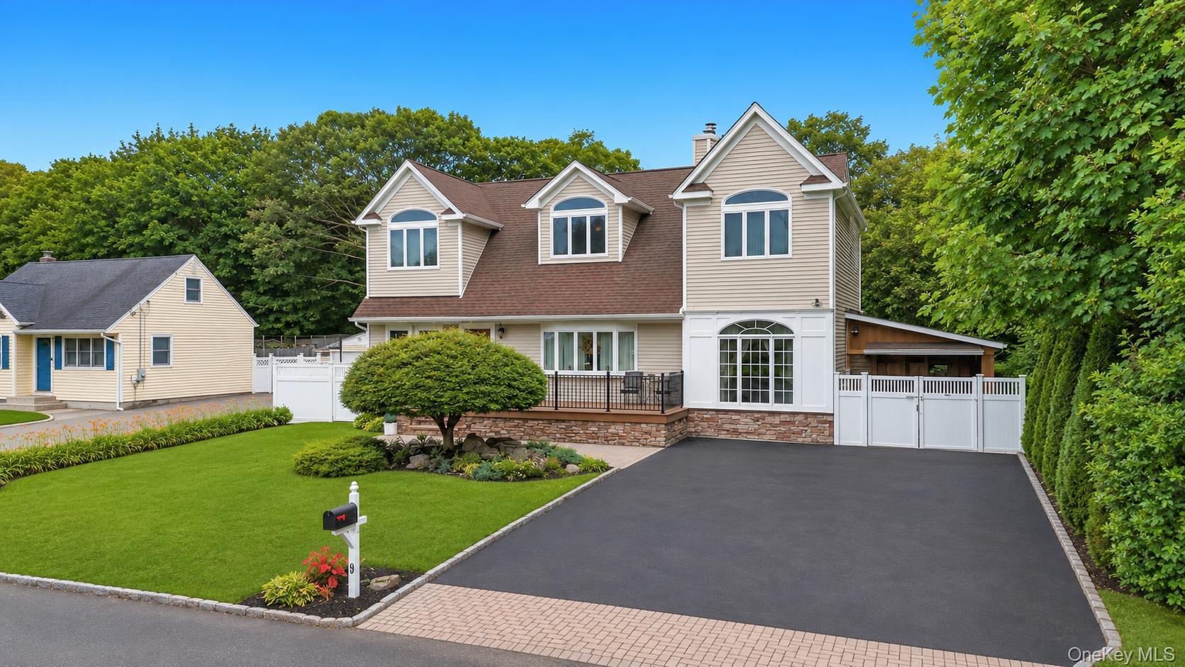 19 Joan Road Bay Shore, NY 11706 - Photo 2 of 50 Modern residence featuring dormer windows, a driveway, and a manicured lawn