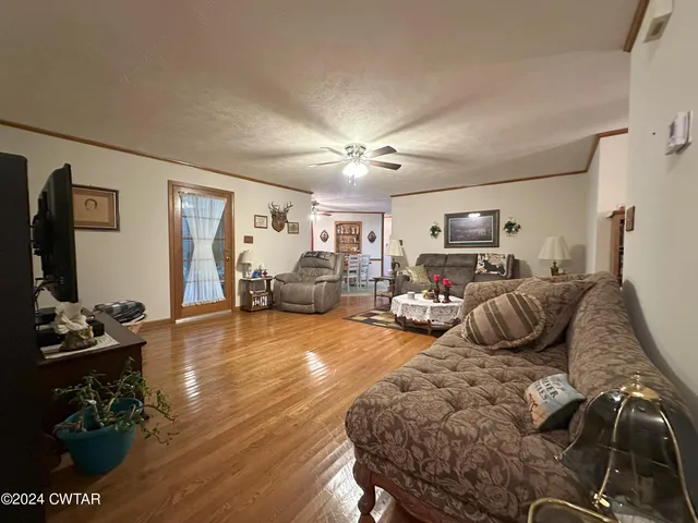 a bedroom with furniture a flat screen tv and a window
