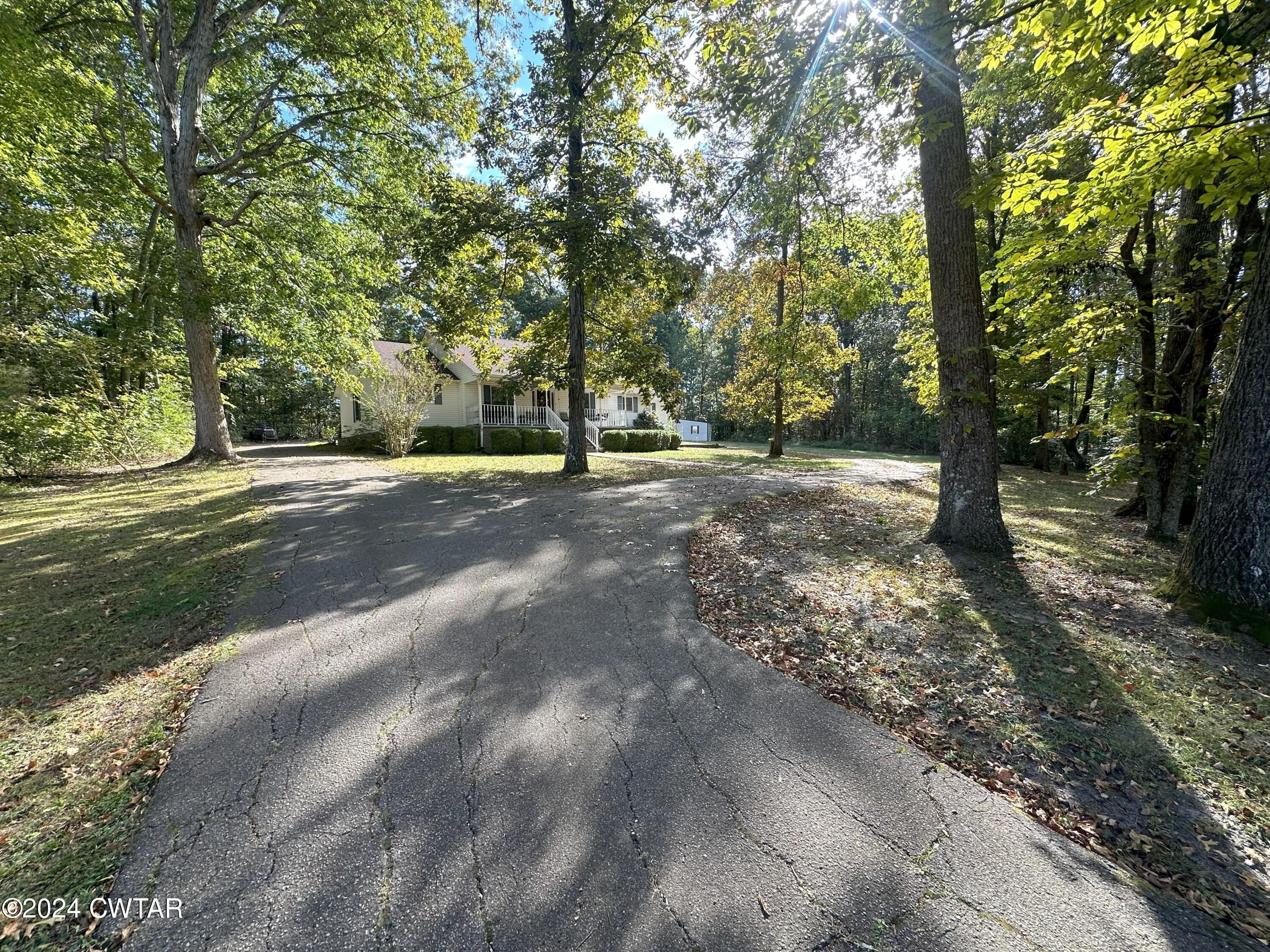 883 Crucifer Road Huron, TN 38345 - Photo 3 of 22 a view of a tree in the middle of a yard