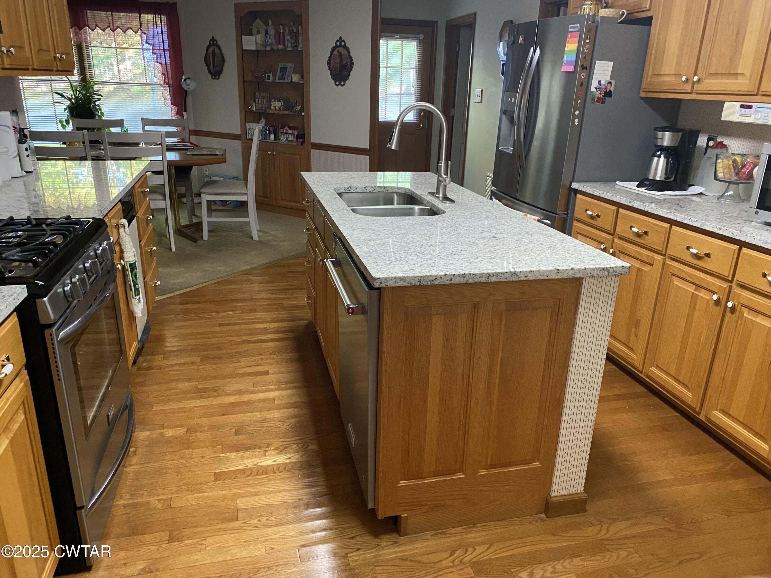 883 Crucifer Road Huron, TN 38345 - Photo 8 of 22 a kitchen with stainless steel appliances granite countertop a sink stove and cabinets