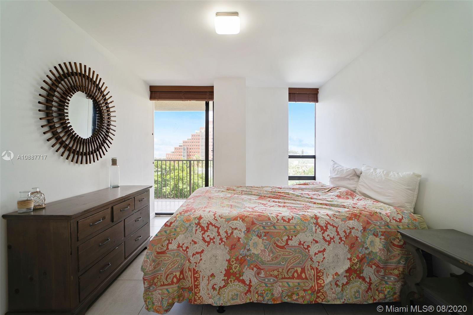 1450 Brickell Bay Drive, Unit 612 Miami, FL 33131 - Photo 15 of 25 a bed sitting in a bedroom next to a window