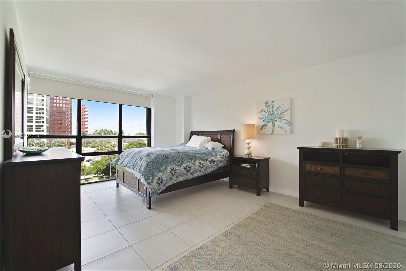 1450 Brickell Bay Drive, Unit 612 Miami, FL 33131 - Photo 16 of 25 a bedroom with a bed and a window