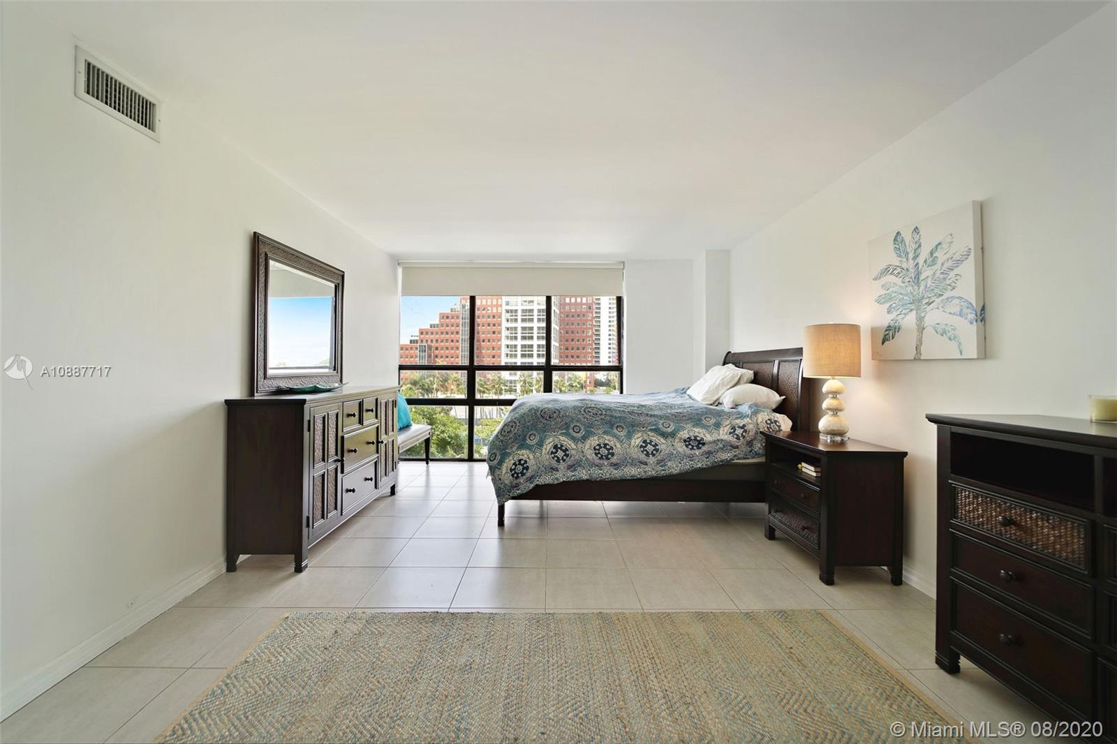 1450 Brickell Bay Drive, Unit 612 Miami, FL 33131 - Photo 17 of 25 a bedroom with a bed and a couch