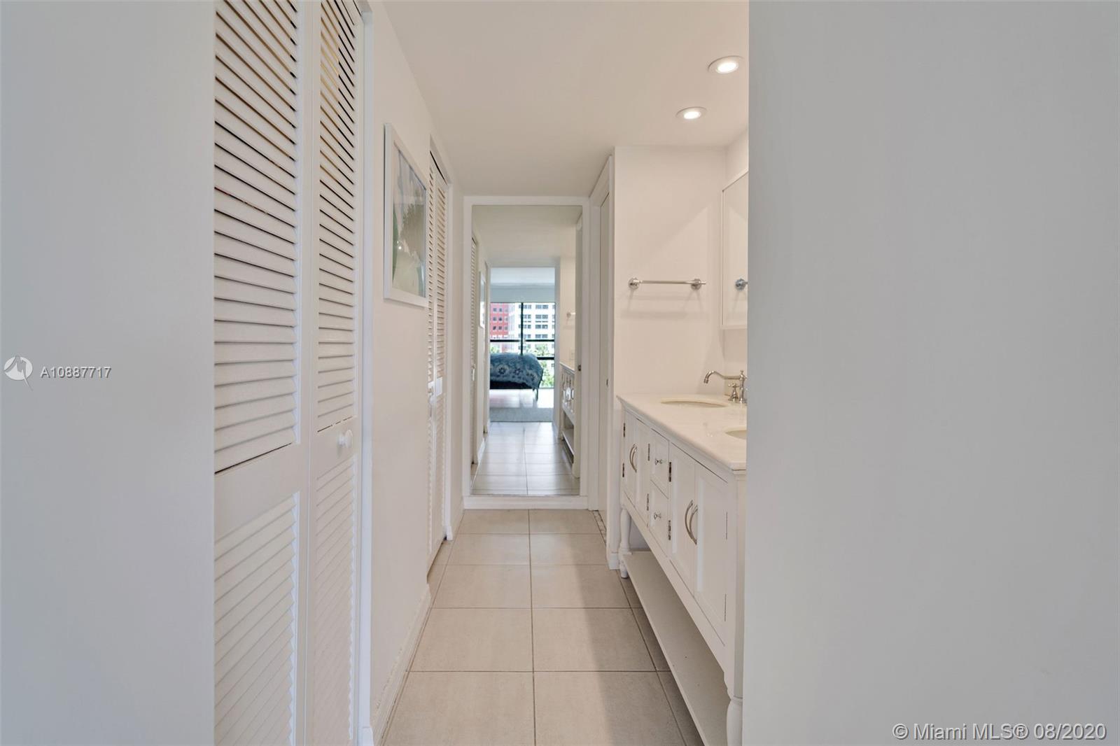 1450 Brickell Bay Drive, Unit 612 Miami, FL 33131 - Photo 18 of 25 a bathroom with a sink and a mirror