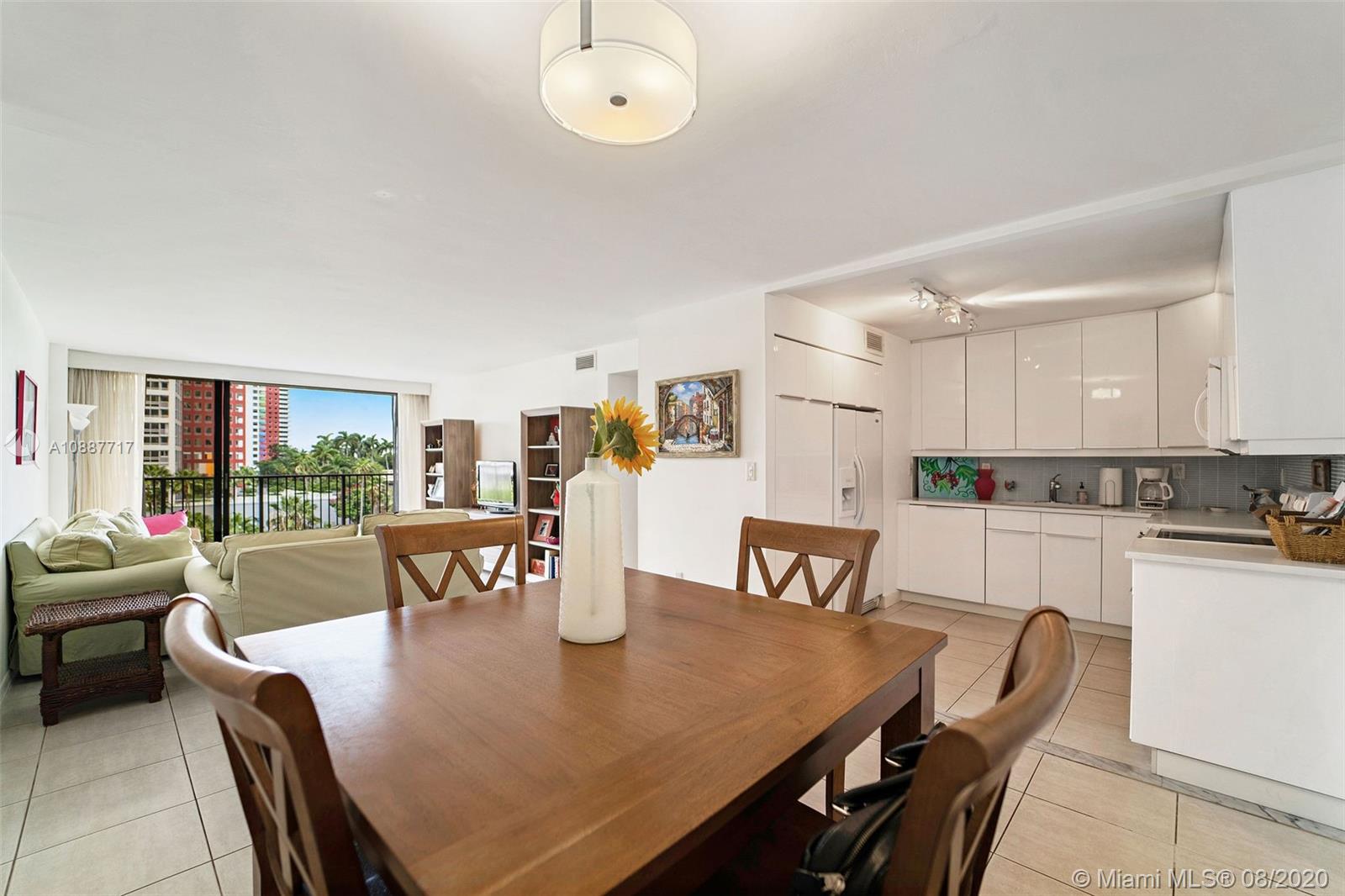 1450 Brickell Bay Drive, Unit 612 Miami, FL 33131 - Photo 2 of 25 a view of a dining room with furniture and wooden floor