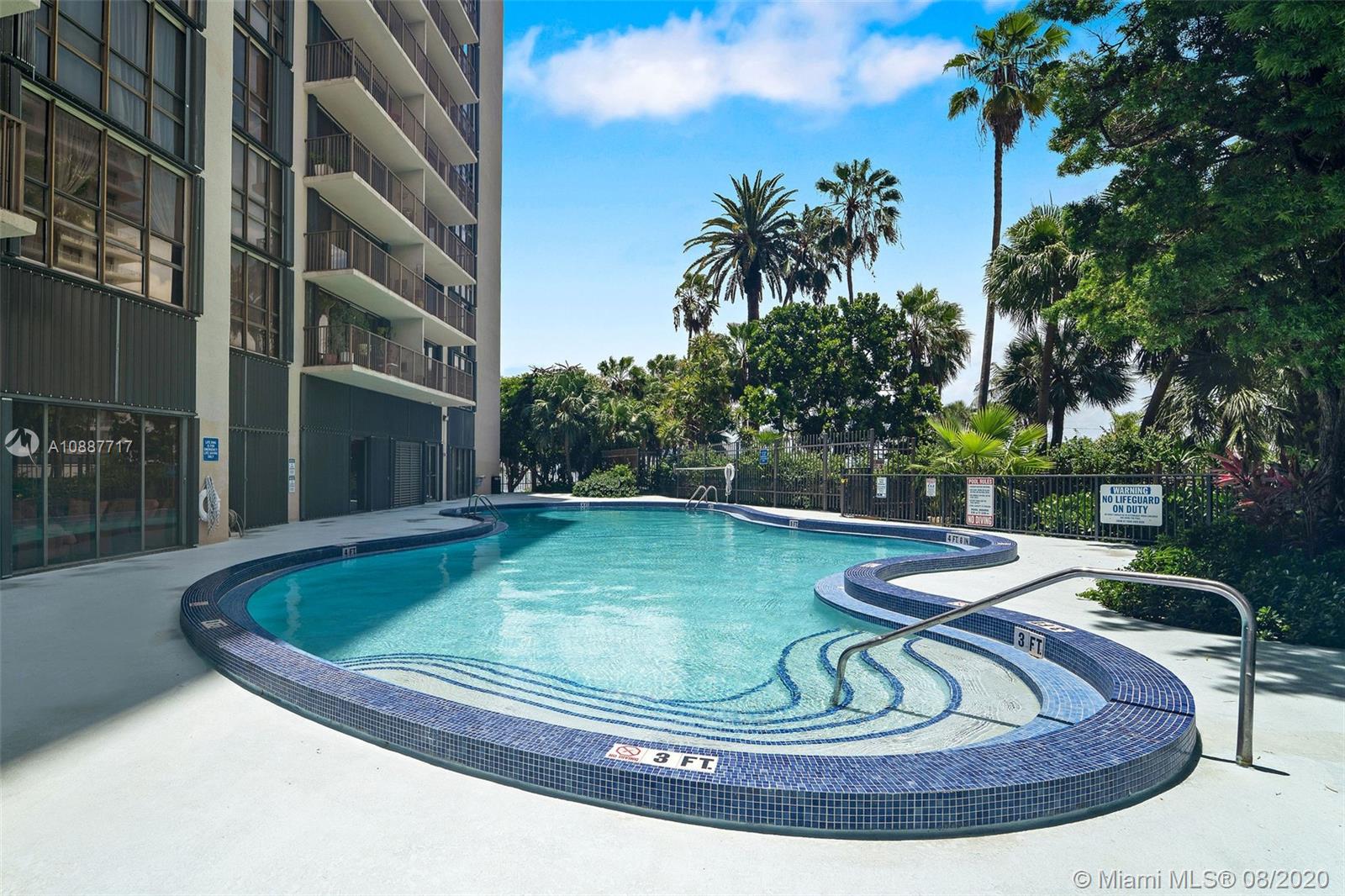 1450 Brickell Bay Drive, Unit 612 Miami, FL 33131 - Photo 22 of 25 a view of a swimming pool with a sitting space