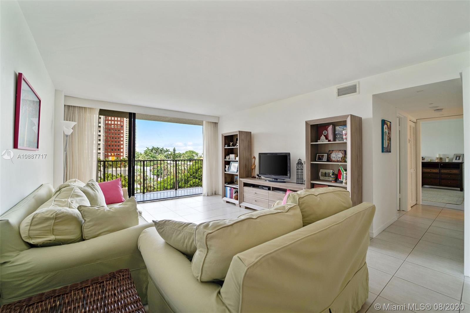 1450 Brickell Bay Drive, Unit 612 Miami, FL 33131 - Photo 7 of 25 a living room with furniture and a flat screen tv