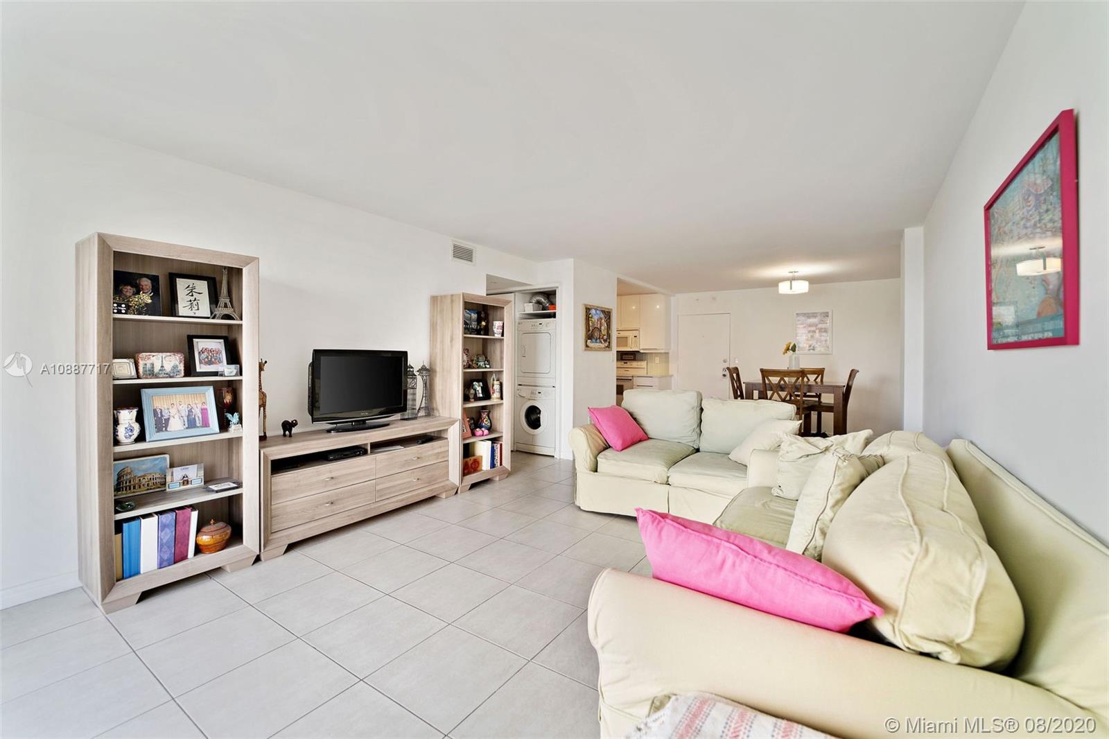 1450 Brickell Bay Drive, Unit 612 Miami, FL 33131 - Photo 8 of 25 a living room with furniture and a flat screen tv