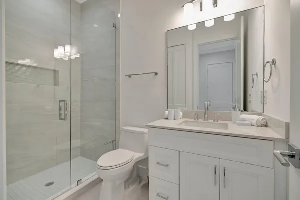a bathroom with a sink toilet and shower