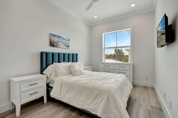 a bedroom with a bed and a flat screen tv