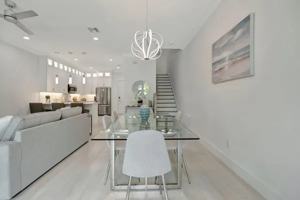 a dining room with furniture and a chandelier